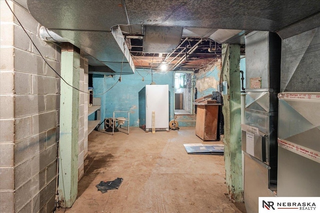 unfinished basement featuring heating unit