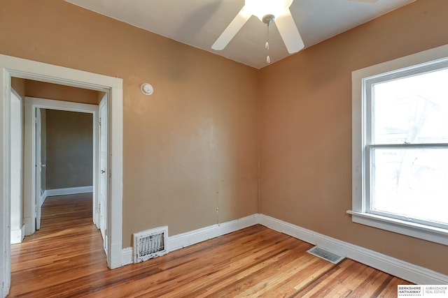 unfurnished room featuring baseboards, visible vents, and light wood finished floors