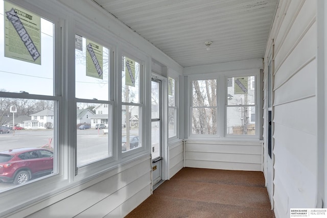 sunroom featuring a residential view and visible vents