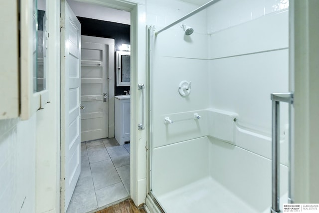 full bathroom with a stall shower and tile patterned flooring