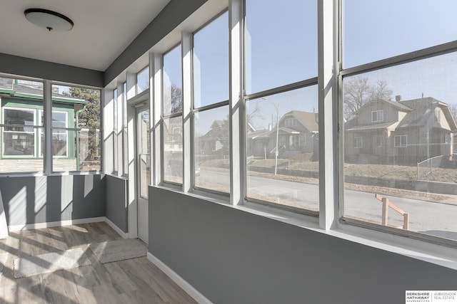 unfurnished sunroom with a residential view