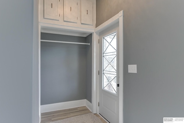 entryway with light wood-style floors, a wealth of natural light, and baseboards