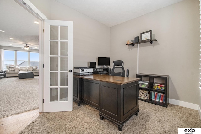 office space with french doors, lofted ceiling, recessed lighting, light colored carpet, and baseboards