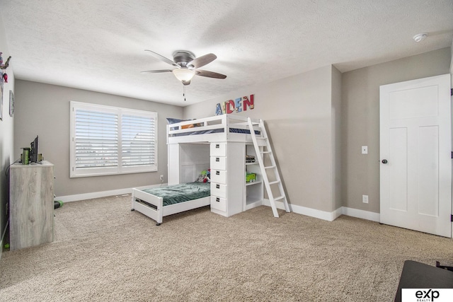 bedroom featuring a textured ceiling, carpet flooring, and baseboards