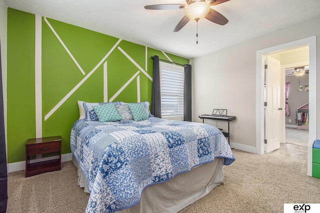 carpeted bedroom with ceiling fan and baseboards