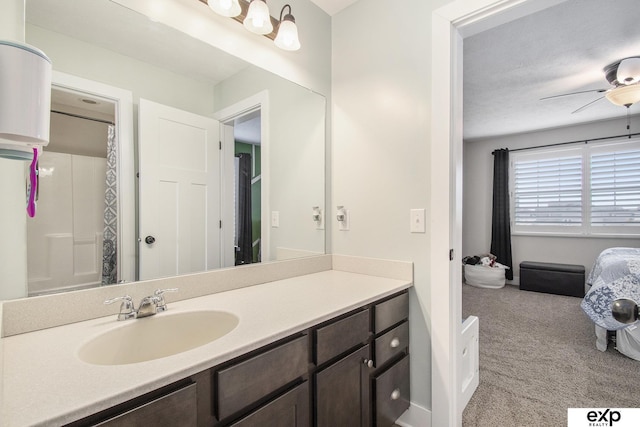 bathroom featuring curtained shower, ceiling fan, and vanity