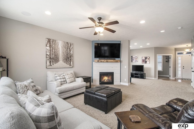 living room featuring carpet, a fireplace, recessed lighting, a ceiling fan, and baseboards