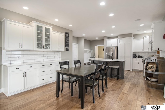 dining space featuring recessed lighting and light wood finished floors