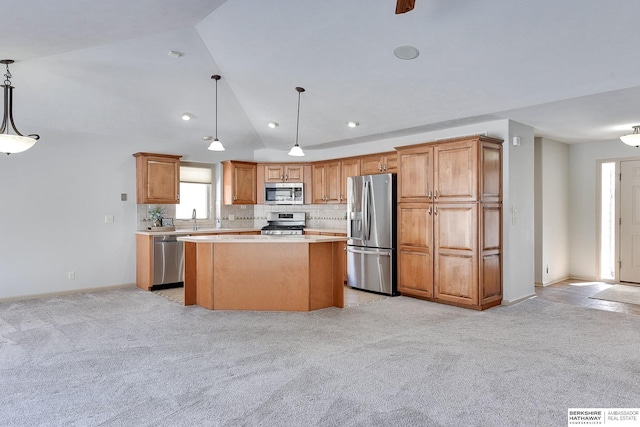 kitchen featuring light carpet, a kitchen island, decorative light fixtures, stainless steel appliances, and light countertops