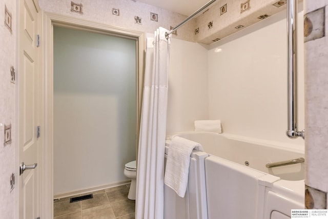 bathroom with toilet, visible vents, shower / bath combo with shower curtain, and tile patterned floors