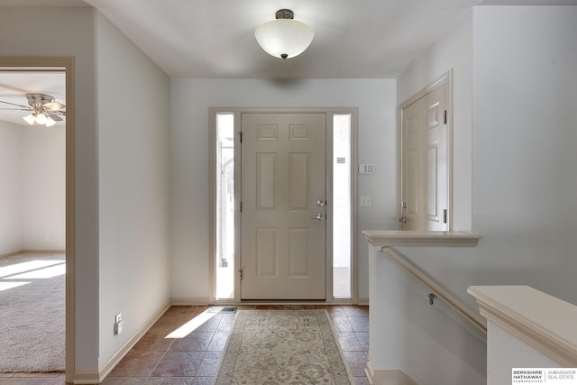 entryway with plenty of natural light and baseboards