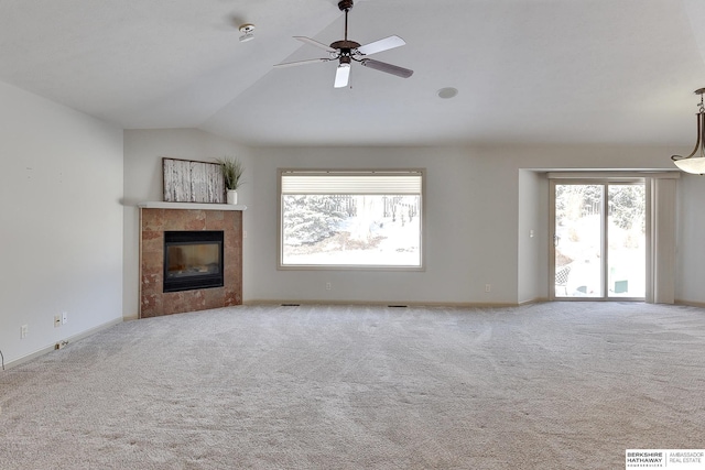 unfurnished living room featuring baseboards, visible vents, light colored carpet, vaulted ceiling, and a fireplace