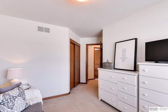 bedroom featuring visible vents, light carpet, and baseboards