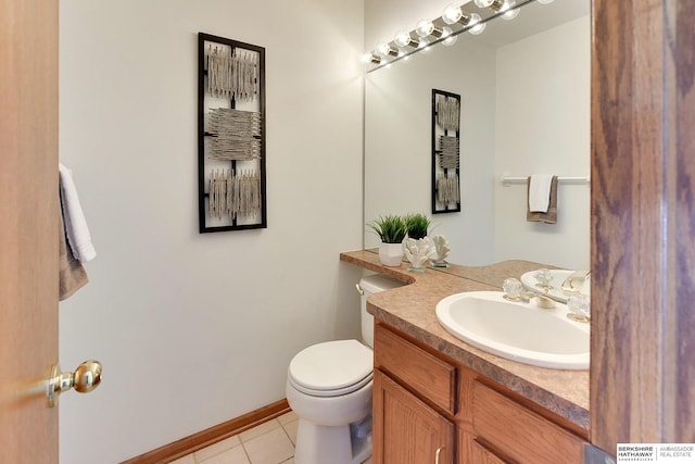 half bathroom featuring vanity, tile patterned flooring, toilet, and baseboards