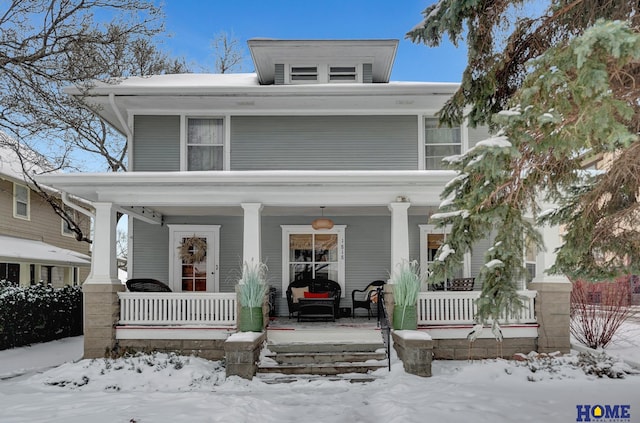 american foursquare style home with covered porch