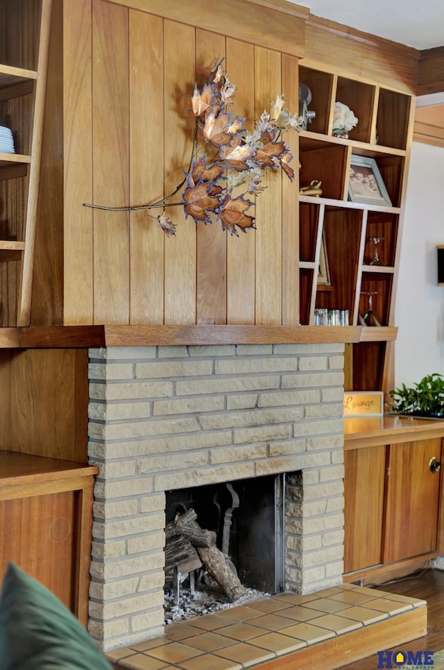 room details featuring a brick fireplace and wood finished floors