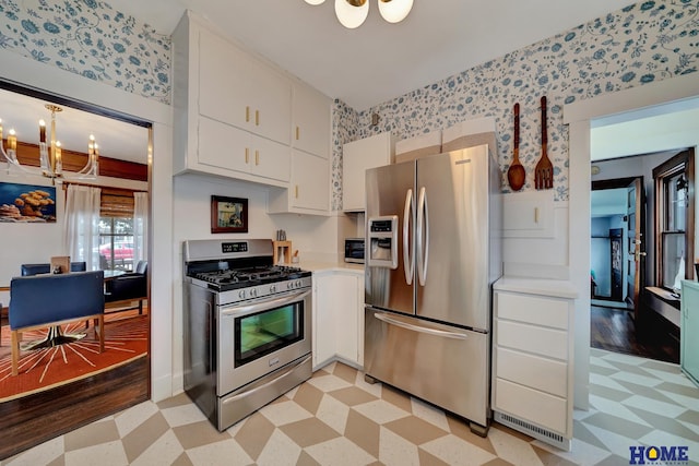 kitchen featuring light floors, white cabinetry, appliances with stainless steel finishes, and light countertops