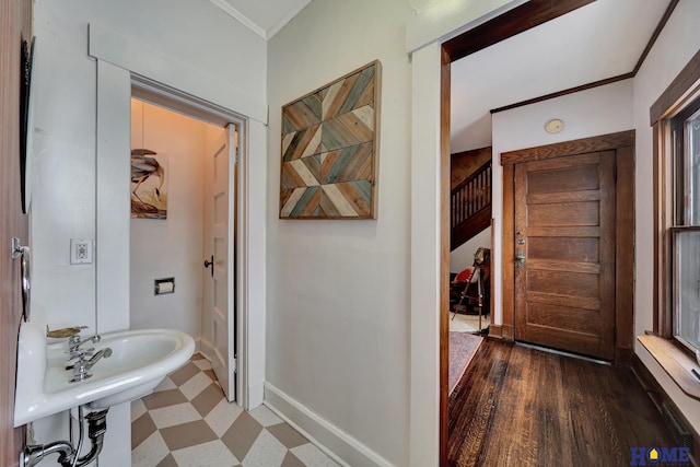 bathroom with baseboards, crown molding, and tile patterned floors