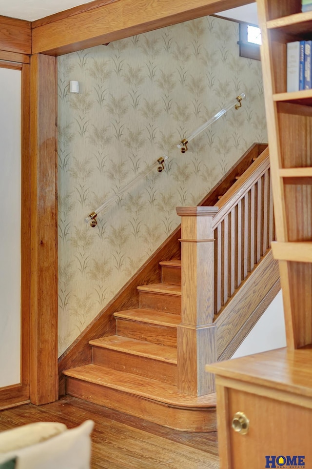 stairway with a sauna and wallpapered walls