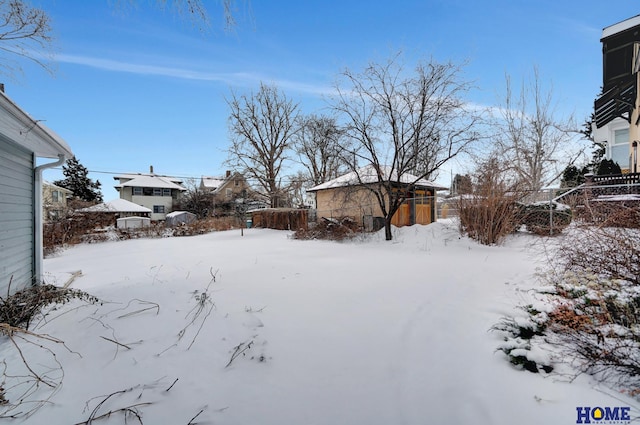 yard layered in snow with fence