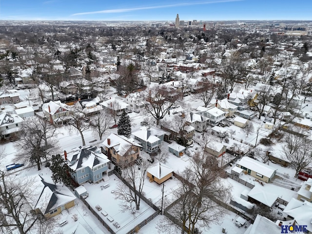 snowy aerial view featuring a residential view