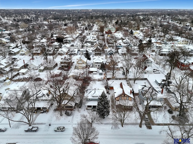 snowy aerial view featuring a residential view