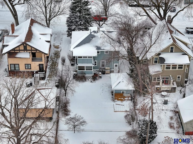 snowy aerial view with a residential view