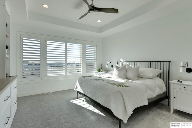 bedroom featuring carpet, a raised ceiling, a ceiling fan, and recessed lighting