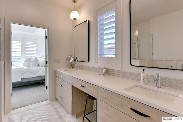 ensuite bathroom featuring double vanity, a sink, and ensuite bathroom