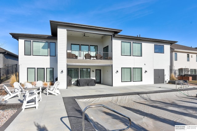 back of house with ceiling fan, a patio, a balcony, and fence