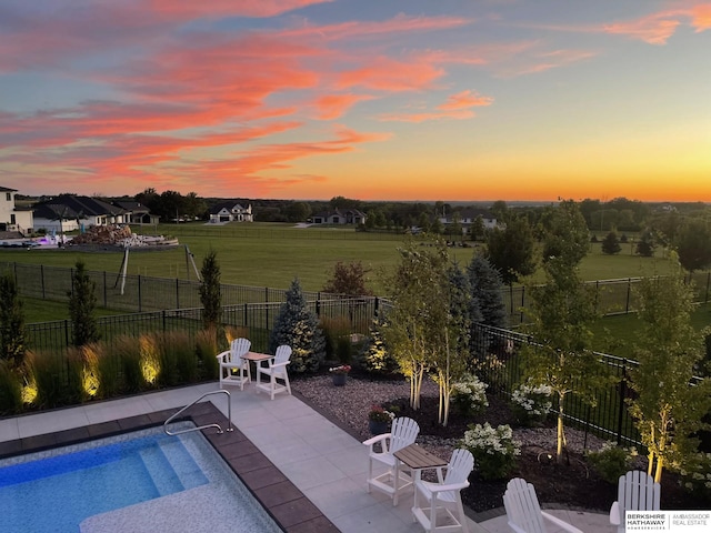 view of pool featuring a patio area, a fenced backyard, a lawn, and a fenced in pool