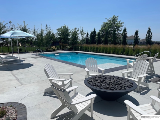 view of pool with a fenced in pool, an outdoor fire pit, a patio area, and fence