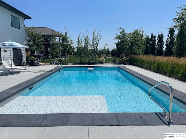 view of swimming pool with a patio area, fence, and a fenced in pool