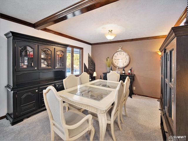 dining space featuring baseboards, ornamental molding, a textured ceiling, and light colored carpet