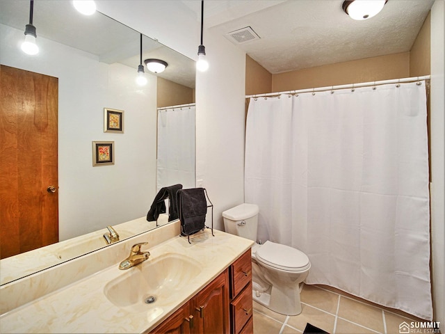 full bathroom featuring visible vents, toilet, a textured ceiling, vanity, and tile patterned floors