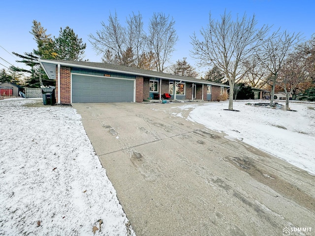 ranch-style home with a garage, concrete driveway, and brick siding