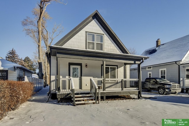 view of front of home with fence and a porch