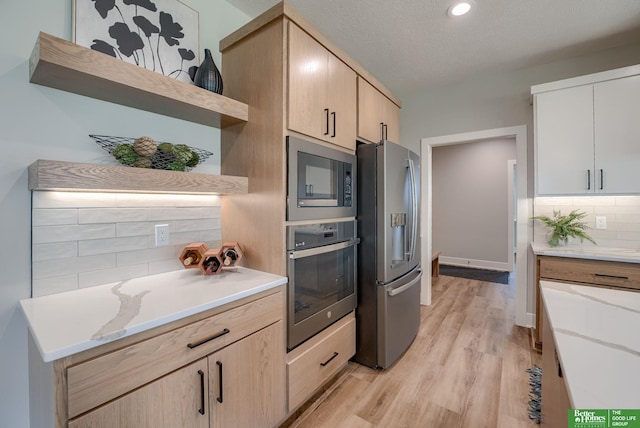 kitchen with open shelves, backsplash, stainless steel appliances, and light countertops