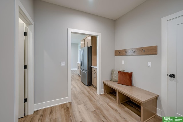 mudroom featuring light wood-style floors and baseboards