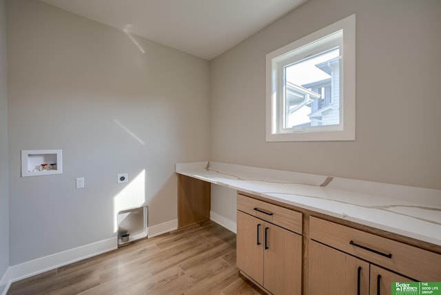 washroom with light wood-style flooring, washer hookup, baseboards, cabinet space, and electric dryer hookup