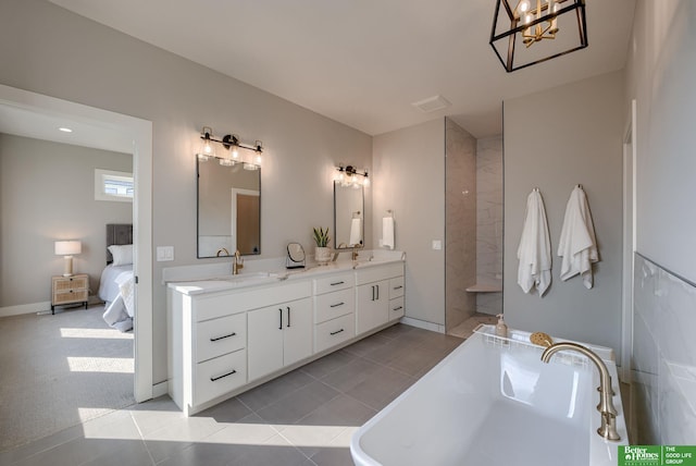 full bath featuring connected bathroom, a sink, visible vents, a soaking tub, and double vanity