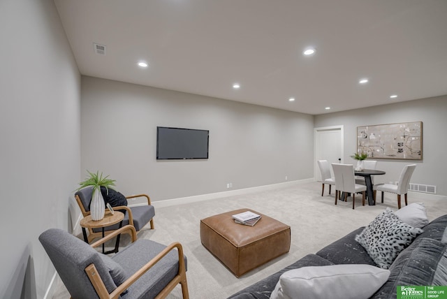 living area featuring recessed lighting, visible vents, light carpet, and baseboards