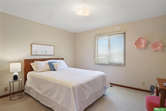 bedroom featuring light carpet, baseboards, and a textured ceiling