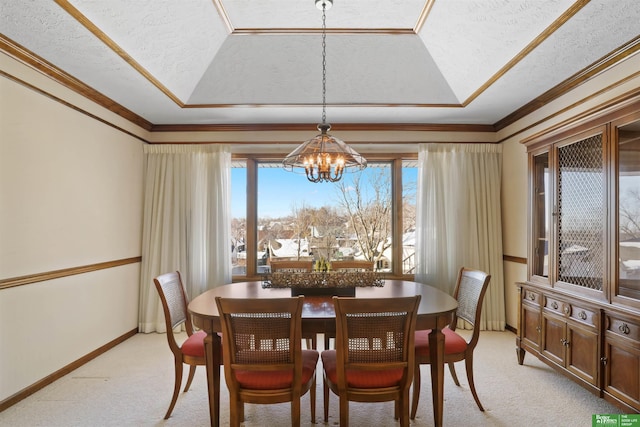 dining area with light carpet, a tray ceiling, and a notable chandelier