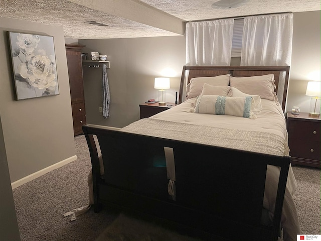 bedroom with carpet, visible vents, a textured ceiling, and baseboards