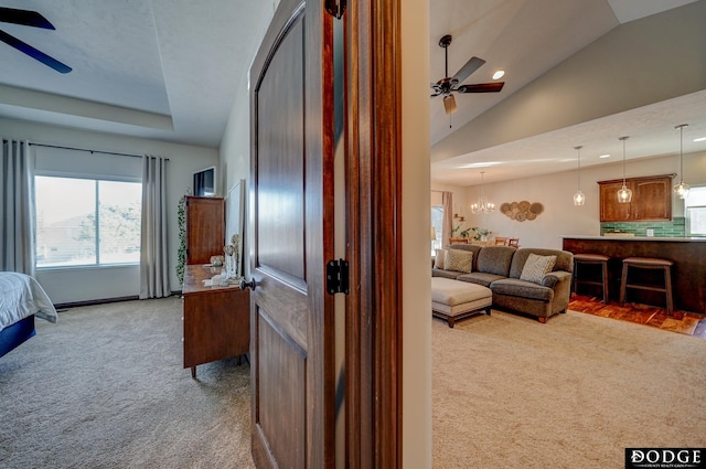 bedroom featuring lofted ceiling, a notable chandelier, and light colored carpet