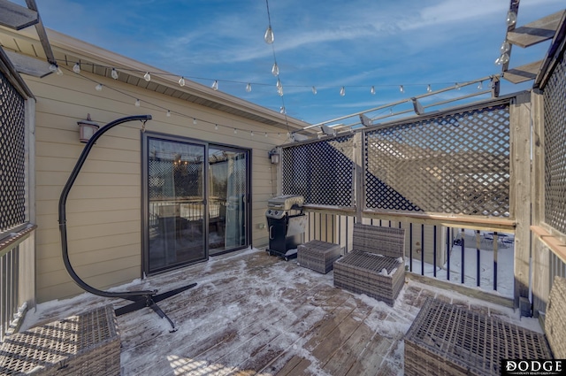 wooden terrace with a grill