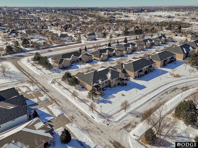 snowy aerial view featuring a residential view