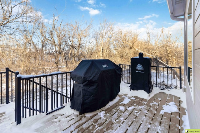 snow covered deck featuring area for grilling