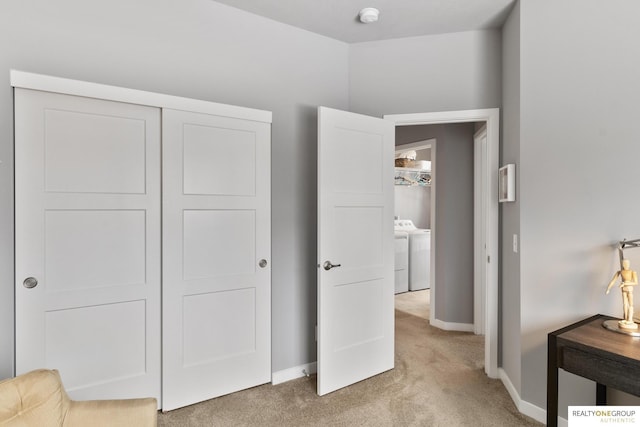 carpeted bedroom featuring baseboards and a closet